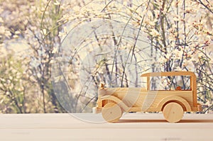 Vintage wooden toy car over wooden table. Nostalgia and simplicity concept.