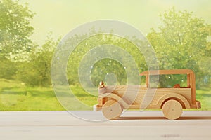 Vintage wooden toy car over wooden table