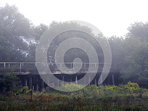 Vintage wooden train bridge during foggy morning