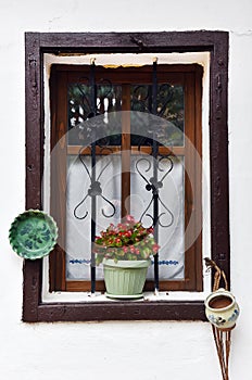 Vintage wooden window frame with hanged pottery