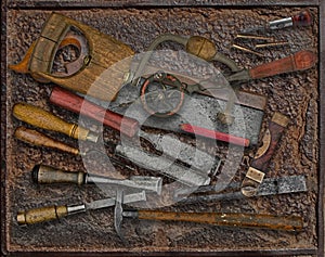 Vintage woodworking tools over rusty plate