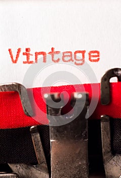 Vintage word typed on typewriter on red