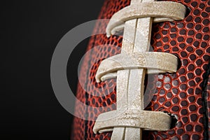 Vintage worn american football ball with visible laces, stitches and pigskin pattern