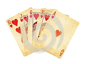 Vintage worn out hearts royal flush poker cards wooden table top photo