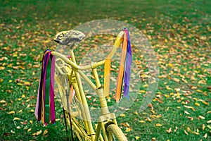 Vintage yellow bicycle on autumn background