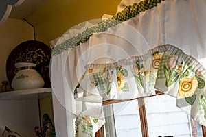 vintage yellow and white curtains in old farmhouse kitchen window