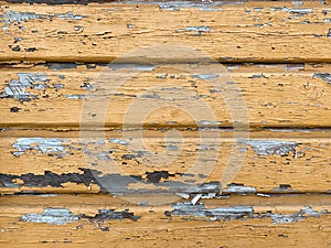 Vintage yellow wood background with peeling paint