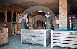 Vintners, wine merchants and cellar workers in production cellar, winery and factory distillery for manufacturing photo