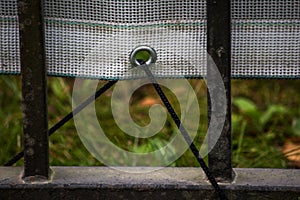 Vinyl banner attached to the fence rope through the metal ring