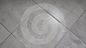Vinyl floor tiles with slate texture. Dark tiles on the floor in the bathroom. Floor tiles on the floor in the bathroom.