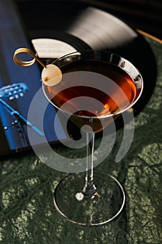 Vinyl Manhattan cocktail on bar table