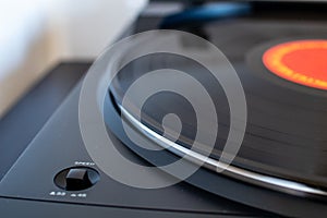Vinyl plate and needle. Vintage record player for vinyl, black platter. Turntable vinyl and needle. Speed button in evidence and