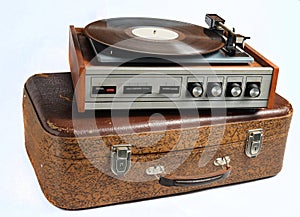 Vinyl player on an old leather suitcase isolated on a whiteVinyl player on an old leather suitcase isolated