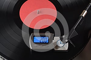 Vinyl player tonearm with digital scale for tracking force adjustment photo
