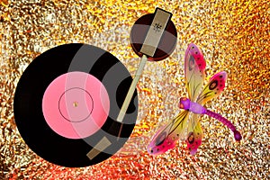 Vinyl record, dragonfly, bokeh background. Record, vintage gramophone. Dragonfly is a symbol of lightness, grace, frivolity, speed