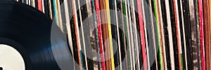 Vinyl record in front of a collection of albums, music concept