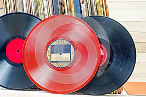 Vinyl record in front of a collection of albums, vintage process. Copy space for text