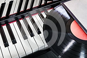 vinyl record lies on the piano keys