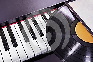 vinyl record lies on the piano keys