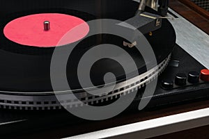 Vinyl record in an old turntable, close-up view