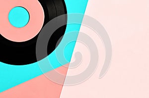 Vinyl record on pastel blue and pink background