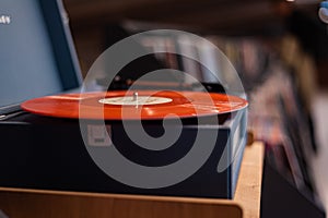 A vinyl record player on the background of a music store window. Vintage vinyl record player.