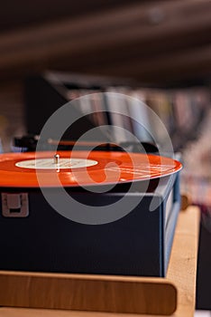 A vinyl record player on the background of a music store window. Vintage vinyl record player.