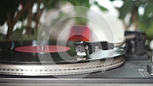 Vinyl record spinning. Close up of needle playing record album on a vintage turntable. Old school record player
