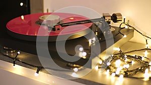 A vinyl record spins in the modern gramophone music player and plays an old disco. Close-up shot of custom vinyl