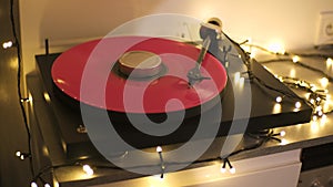A vinyl record spins in the modern gramophone music player and plays an old disco. Close-up shot of custom vinyl