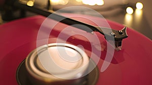 A vinyl record spins in the modern gramophone music player and plays an old disco. Close-up shot of custom vinyl