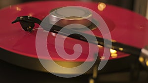 A vinyl record spins in the modern gramophone music player and plays an old disco. Close-up shot of custom vinyl