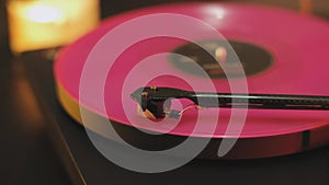 A vinyl record spins in the modern gramophone music player and plays an old disco. Close-up shot of custom vinyl