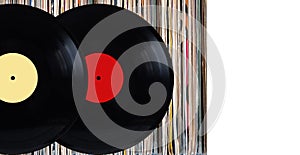 Vinyl records with color labels in front of pile of many close standing vinyl disc in old color covers over white background