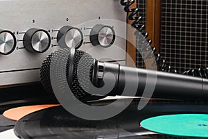 Vinyl records and microphone on the background of an old turntable