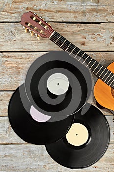 Vinyl records and wooden guitar.