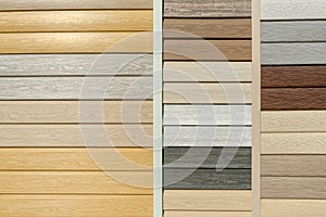 Vinyl siding with imitation wood texture in bright palette of colors. Plastic wall covering for exterior decoration of house.