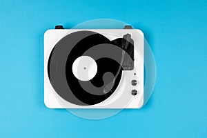 Vinyl turntable with vinyl plate on a blue background. Modern gramophone record player. Retro sound technology to play music