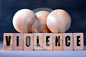 VIOLENCE - word on wooden blocks on dark blue background