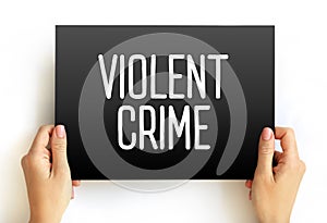 Violent crime - in which an offender or perpetrator uses or threatens to use harmful force upon a victim, text on card concept photo