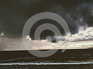 Violent sea thunder storm with windy rain and rolling waves.