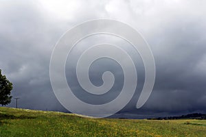 A violent storm is over a field