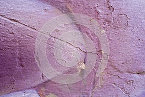 Violet abstract paint on a white cracked wall