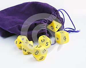 Violet bag, or pouch. Dices for rpg, board games, tabletop games or dungeons and dragons.