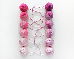 Violet balls of yarn  on white background