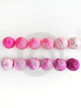 Violet balls of yarn on white background