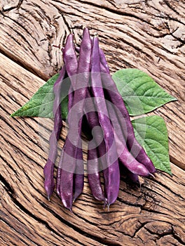 Violet beans on the old wood.
