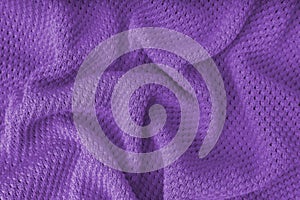 Violet crumpled knitting wool texture background.