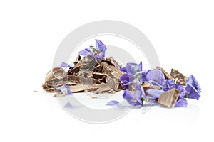 Violet flavored chocolate shavings with pieces of violet flowers.