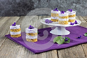 Violet flower small cakes with mascarpone cream